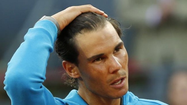 Rafael Nadal running fingers through hair transplant